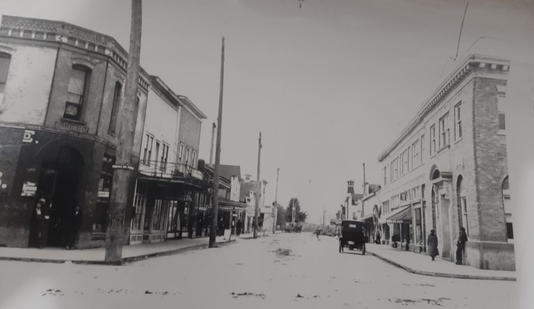 A historic photo of Cowlitz Street with the Vault building on the right side.